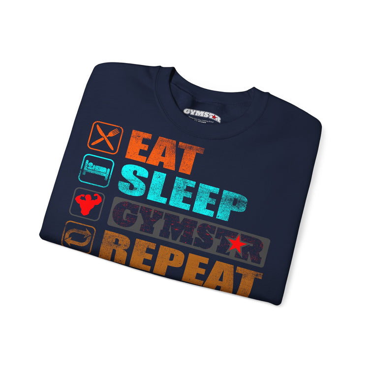A navy blue t-shirt with a distressed graphic print reading 'EAT SLEEP GYMSTAR REPEAT' in orange, teal, and dark gray, accompanied by small fitness-themed icons on the left side. The shirt is displayed on a clean white background.