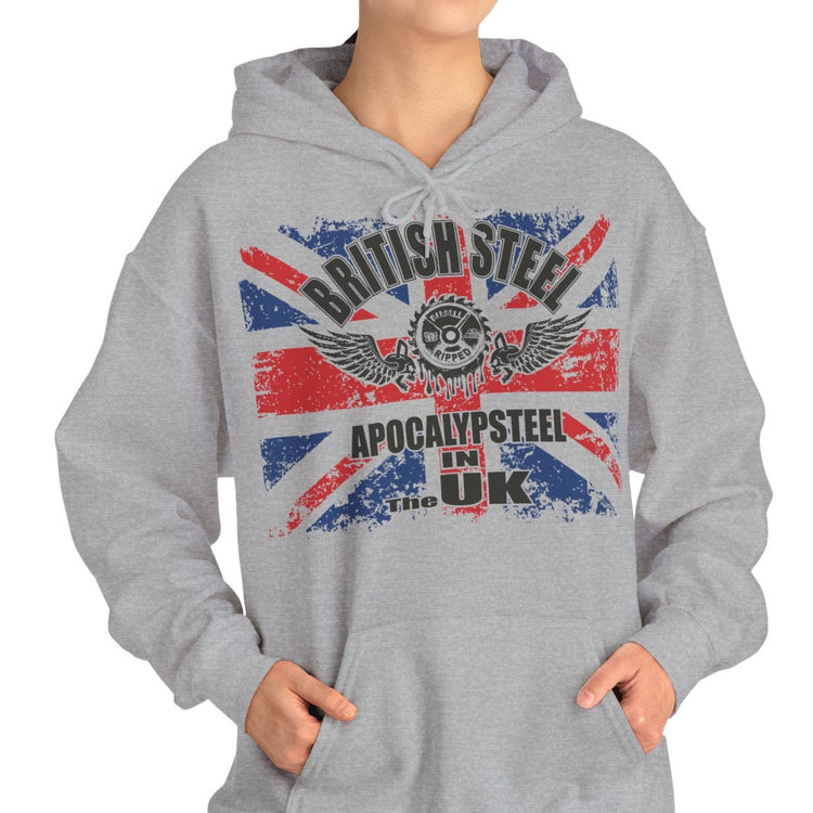 A woman modeling a light gray pullover hoodie with a distressed Union Jack graphic and the text 'BRITISH STEEL' and 'APOCALYPSEE IN THE UK' on the front, set against a plain white background.