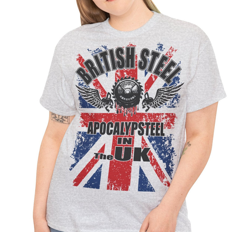A woman modeling a light heather gray t-shirt with a distressed graphic that reads 'BRITISH STEEL' and 'APOCALYPSE! IN THE UK' over a Union Jack design, paired with blue jeans against a plain white background.