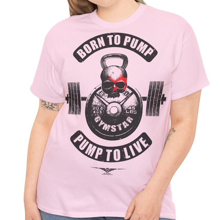 A woman modeling a light pink short-sleeve t-shirt with a black and red gym-themed graphic that reads 'BORN TO PUMP' and 'PUMP TO LIVE' around a kettlebell and barbell design.