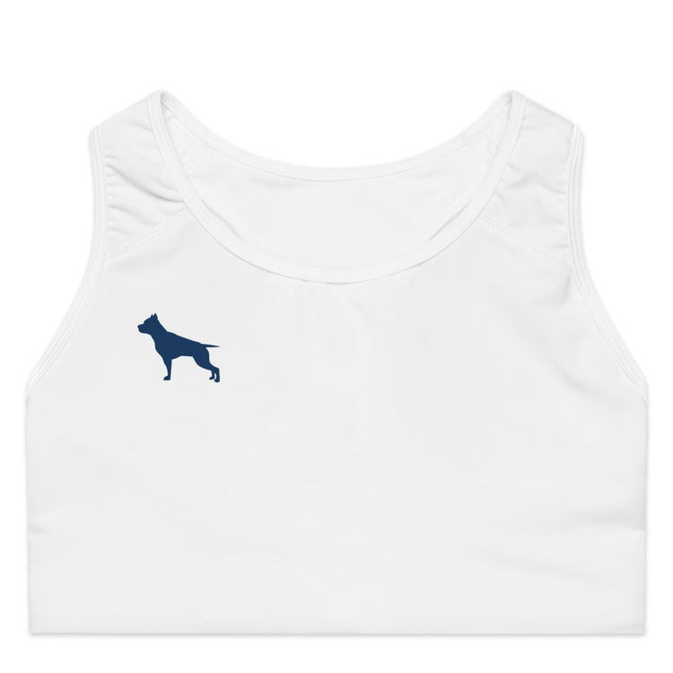 A female model wearing a white sports bra and matching white joggers, posing with a peace sign.