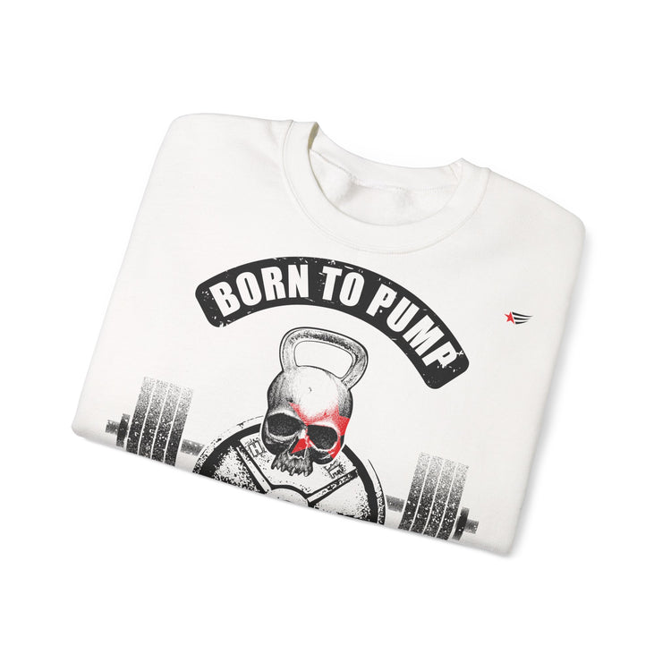 A folded white crewneck sweatshirt featuring a graphic print of a skull lifting a kettlebell with a barbell, under a black arched banner that reads 'BORN TO PUMP'. The sweatshirt is photographed on a clean white background.