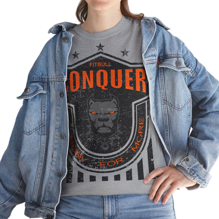 Person wearing a grayFitbull  t-shirt with a motivational Conquer graphic design and a denim jacket.
