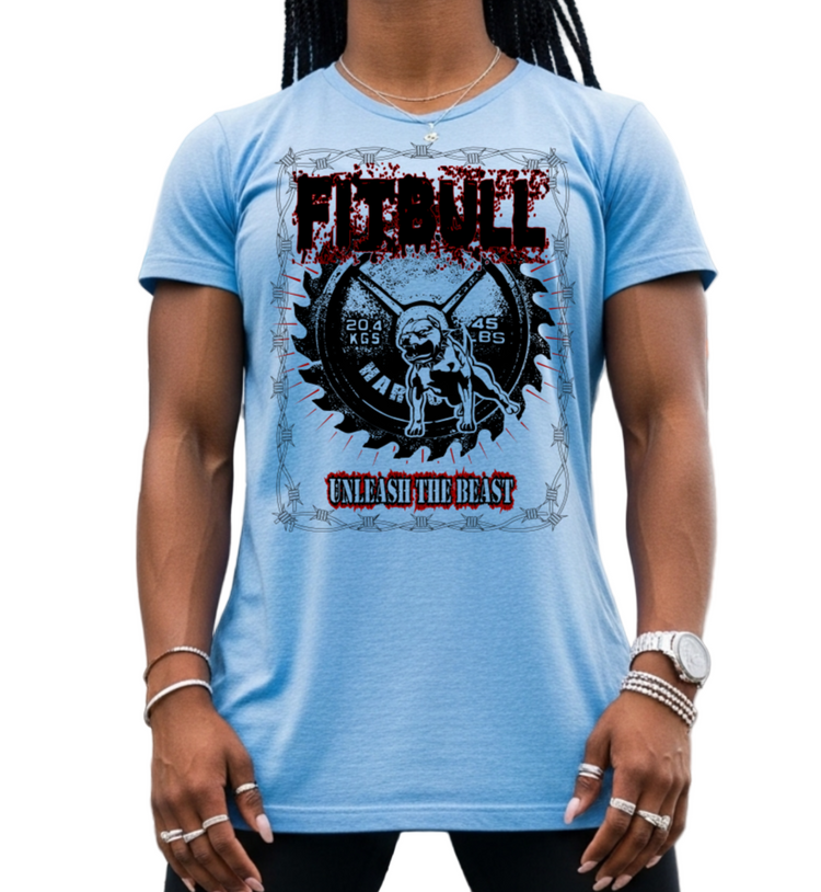Woman wearing a blue FITBULL t-shirt with a motivating graphic design with a barbel, with a pitbull and text UNLEASH THE BEAST: