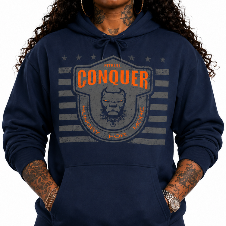 Person wearing a Fitbull navy hoodie with 'Conquer' logo and a black cap on a white background