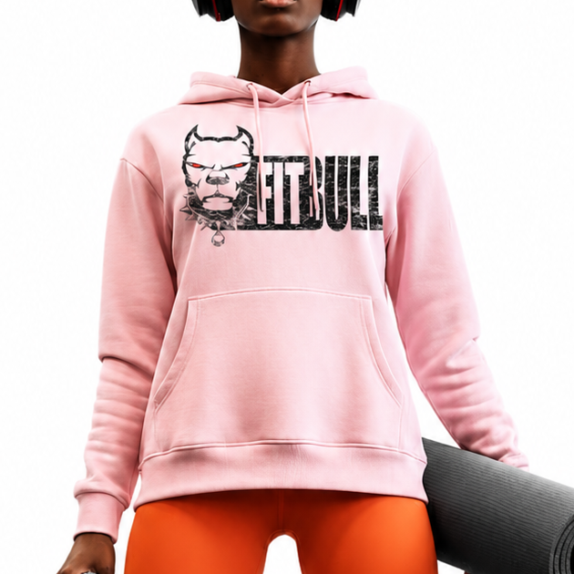 Person wearing a pink Fitbull hoodie with a logo, orange leggings, and red sneakers, holding a yoga mat and towel.