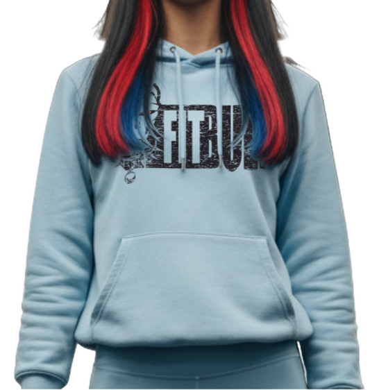 Woman in light blue athletic hoodie outfit with red accents in a gym setting