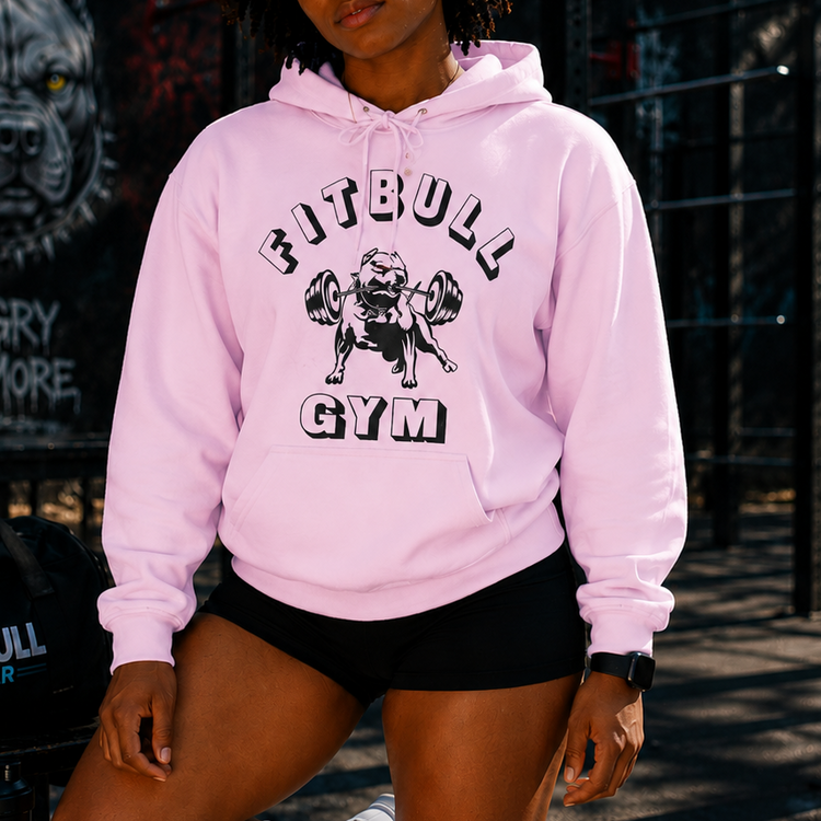 Person wearing a pink 'Fitbull Gym' hoodie in an outdoor setting.