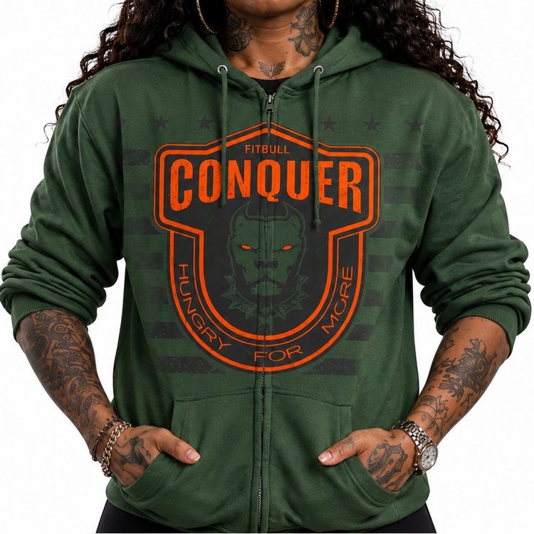 Person wearing a green Fitbull hoodie with 'Conquer' logo and text, black cap with logo.