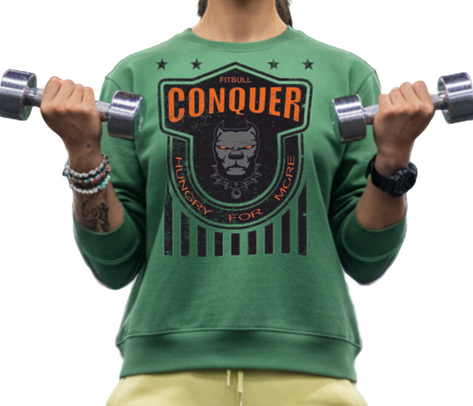 Person lifting weights in a gym wearing a green fitness Fitbull 'Conquer' sweatshirt.