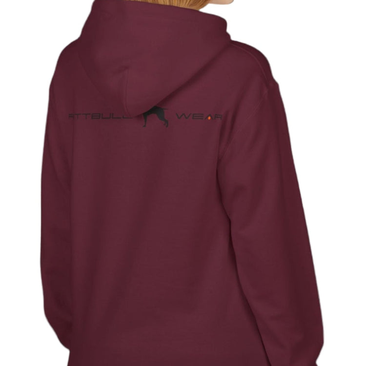 woman wear cherry-colored sporty hoodie for fitness and crossfit by the Fitbull brand, branded with a logo and a motivating motif side view