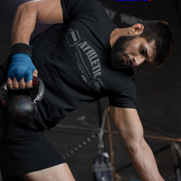 Person lifting a kettlebell in a gym setting with 'GYMSTAR' branding.