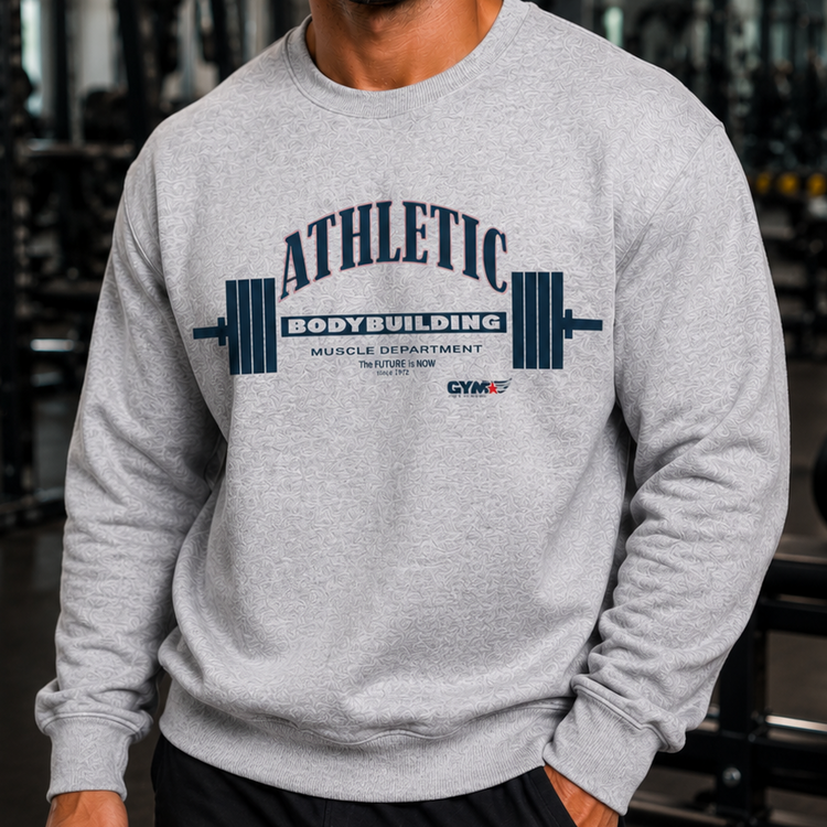 Man wearing a gray Gymstar sweatshirt with 'Athletic Bodybuilding' text in a gym setting