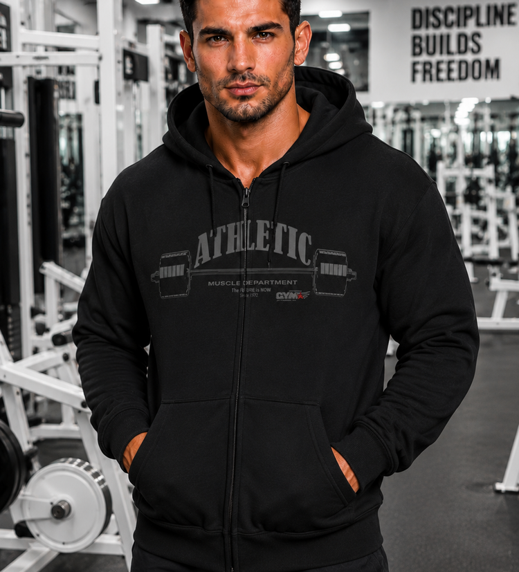 Man wearing a black Gymstar Athletic zipp hoodie with text in a gym setting