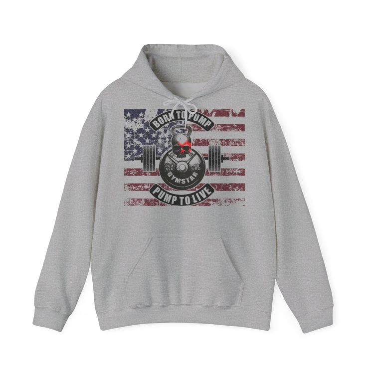 A light gray heather pullover hoodie with a distressed American flag graphic on the chest, featuring a weight plate and barbell design with the text 'BORN TO PUMP' and 'PUMP TO LIVE' around a central skull and crossbones motif.