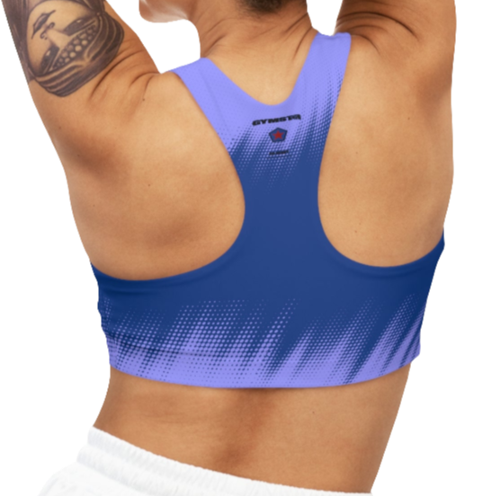 A women's athletic sports bra Gymstar, shown from the back. It features a bright and bluer color scheme with a dotted, gradient pattern radiating from the bottom. The straps are solid blue and form a racerback style. The brand's logo, a red star within a circle of smaller stars, is printed on the upper back, along with the "GYMSTAR" brand name.