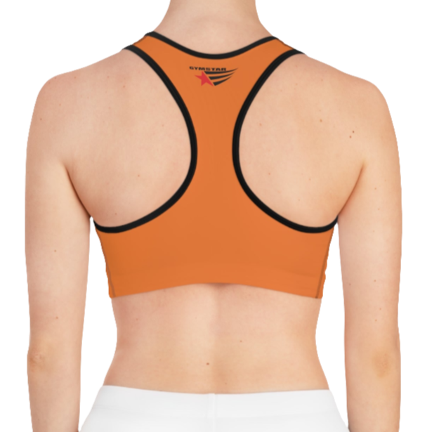 A women's solid orange athletic sports bra Gymstar, shown from the back. It features black trim and a racerback style. The brand's logo is visible on the upper back, just below the neckline.
