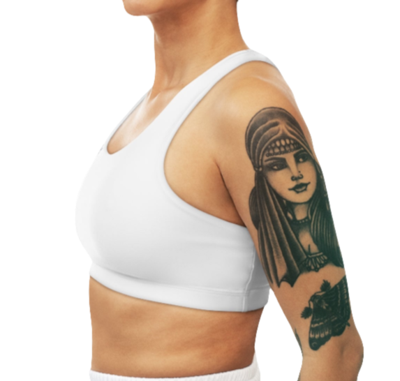 A women's solid white athletic sports bra Gymsatr, shown from the side. It has a scoop neckline and a racerback style. The sports bra is worn by a person with tattoos on their upper arm.