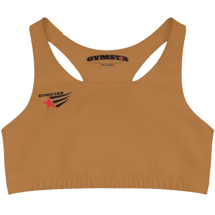 A women's solid brown athletic sports bra Gymstar. It has a scoop neckline and a racerback style. A logo with a red star and three black stripes is on the left chest, with the brand name "GYMSTAR" in black text above it. The main brand tag with "GYMSTAR" is visible on the inner back neckline.