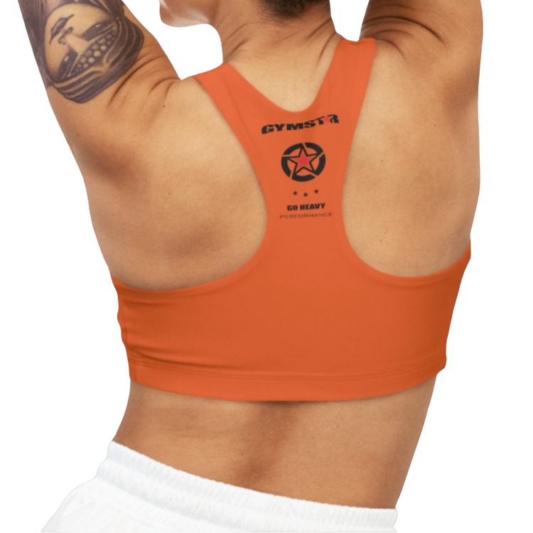 A woman wearing Orange,  sports, fitness bra from the Gimstar brand, with  a small logo on the left side. Rear view.
