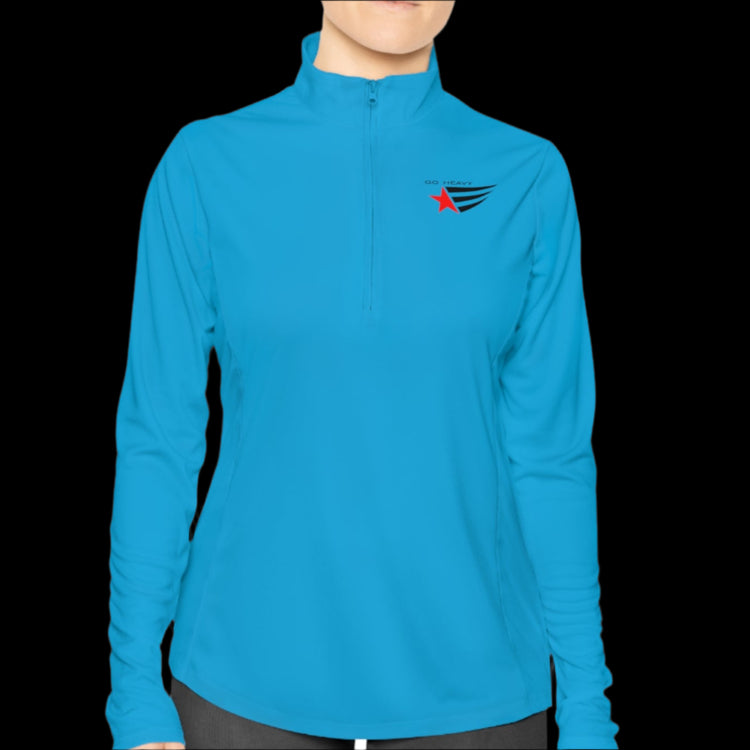 A person wearing a blue half-zip sweatshirt with logo printed on the front.