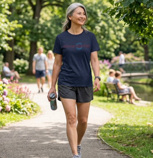 Woman walking in a park wearing a navy blue Gymstar t-shirt with a logo.