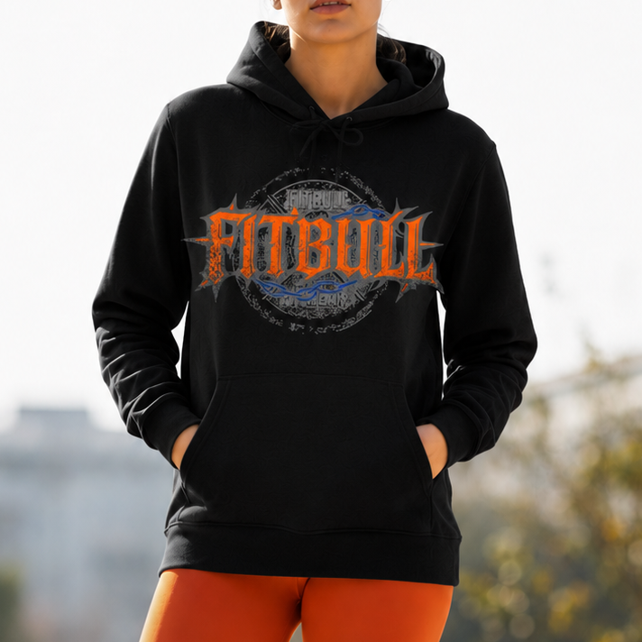 Woman wearing a black hoodie with 'Fitbull' logo and orange leggings outdoors.