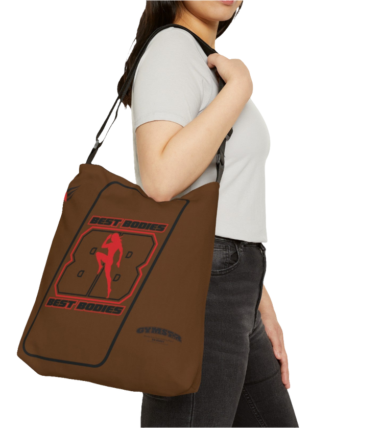 A person carrying a brown tote bag with 'GYMSTAR' branding and a graphic Best Bodies design that includes a silhouette of a person lifting weights.