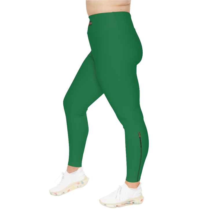 A woman wearing green high-waisted fitness leggings Gymstar with a logo on the waistband, paired with white sneakers. Left side view.