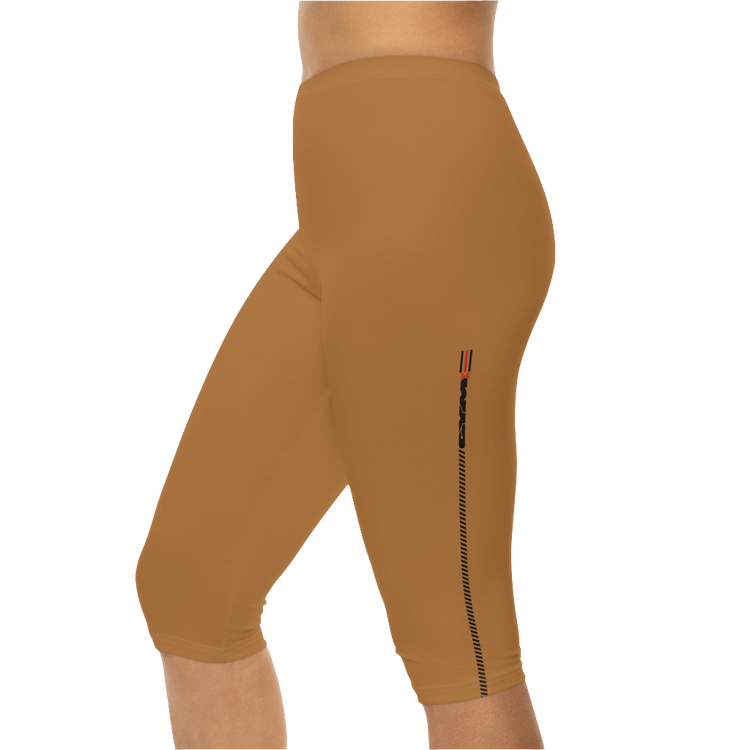 A woman wearing pair of brown Gymstar fitness leggings with a small logo on the left thigh area, designed for women. Left side close up view.