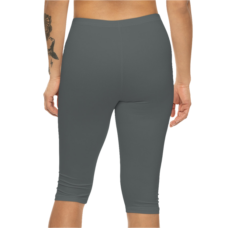 A woman wearing pair of gray Gymstar brand fitness leggings featuring a mid-rise waist and a logo, designed for yoga and other workouts. Rear close up view.