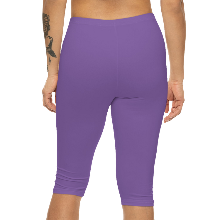 A woman wearing pair of purple fitness Gymstar leggings with a small logo on the upper left thigh area, designed for women's workouts. Rear close up view.