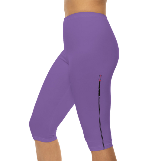 A woman wearing pair of purple fitness Gymstar leggings with a small logo on the upper left thigh area, designed for women's workouts. Left side close up view.