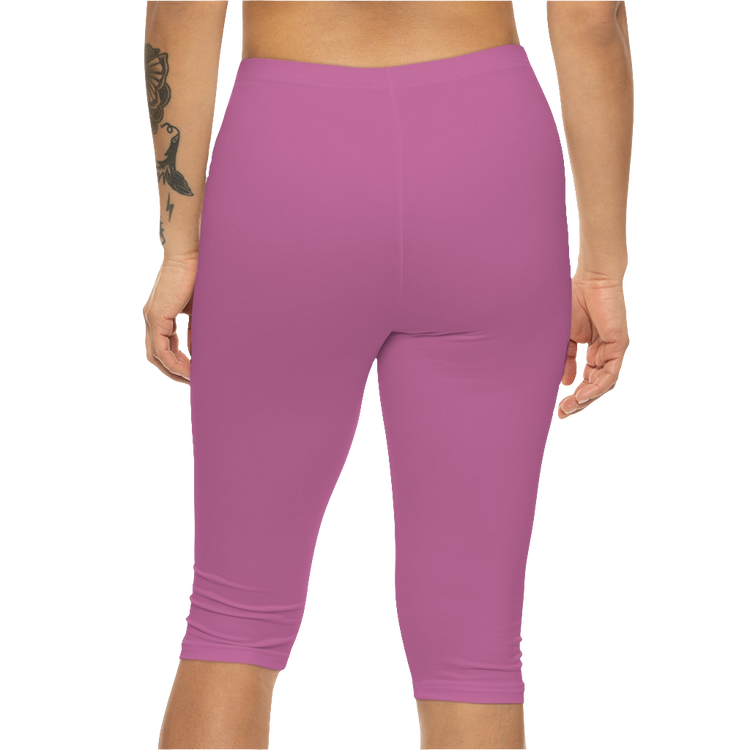 A woman wearing a pair of red-purple Gymstar fitness leggings with a small logo on the left thigh area, designed for women training and joga. Rear close up view.