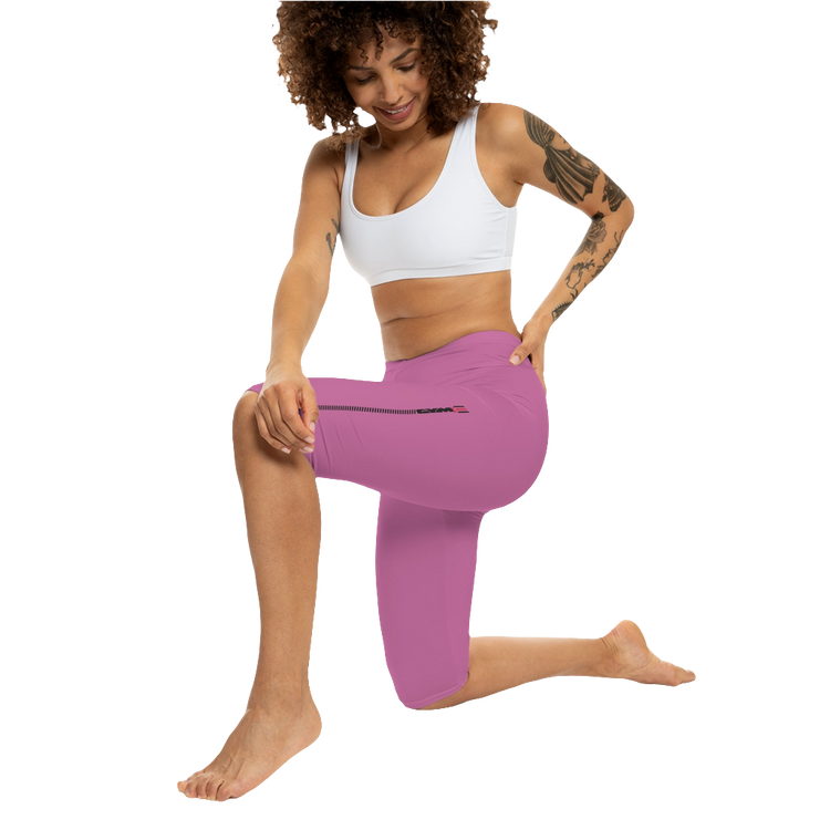 A woman wearing a pair of red-purple Gymstar fitness leggings with a small logo on the left thigh area, designed for women training and joga. Action front  view.