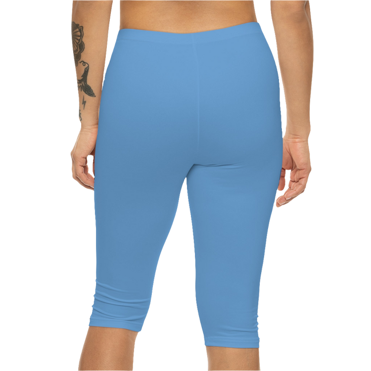 A woman wearing pair of blue fitness Gymstar leggings with a small logo on the upper left thigh area, designed for women's workouts. Rear close up view.