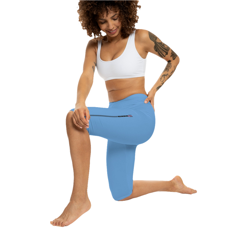 A woman wearing pair of blue fitness Gymstar leggings with a small logo on the upper left thigh area, designed for women's workouts. Front action view.