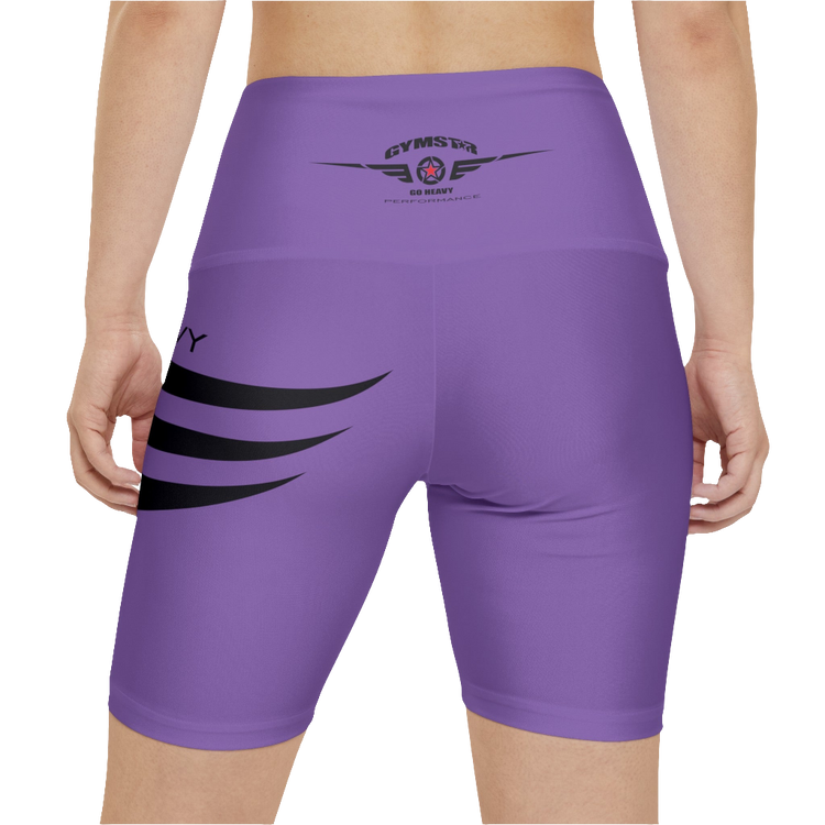 A woman wearings pair of purple Gymstar women's workout leggings with 'GYMSTAR' and 'GO HEAVY' text, along with a star graphic, on a person mid-section view. Rear close up view.