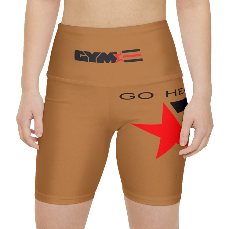 A woman wearings pair of brown Gymstar brand fitness leggings with a red star and brand logo on the side, designed for women. Front close up view.