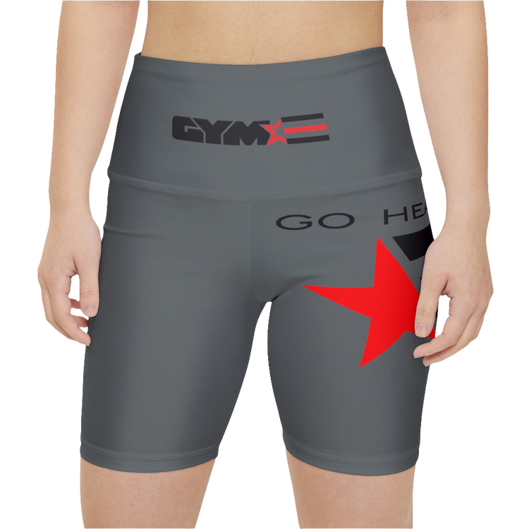 A pair of gray Gymstar workout leggings with a logo on the left thigh and a red star on the right thigh, alongside a mid-rise waist. Front close up view.