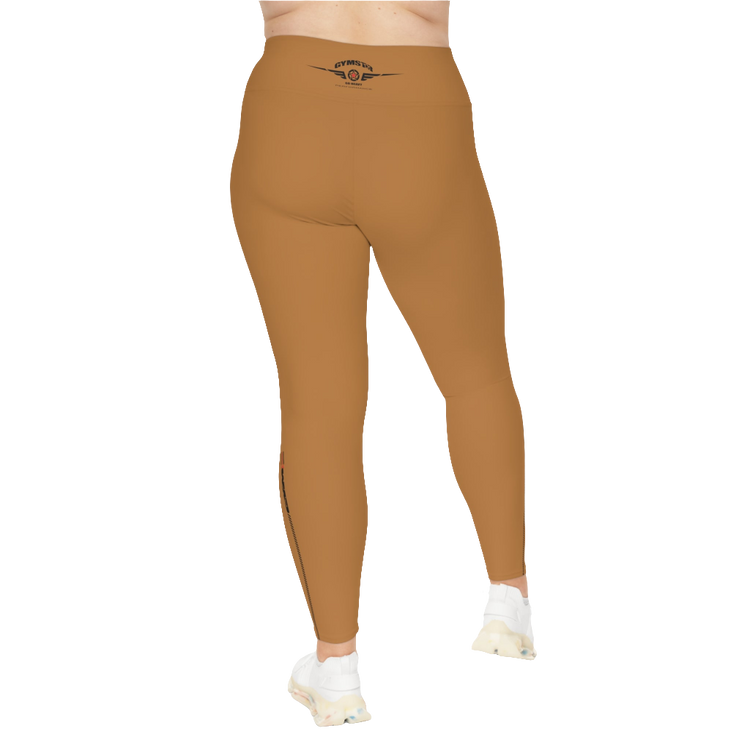 A woman wearing pair of brown high-waisted Gymstar fitness leggings with a logo on the upper left thigh, paired with white sneakers. Rear view.