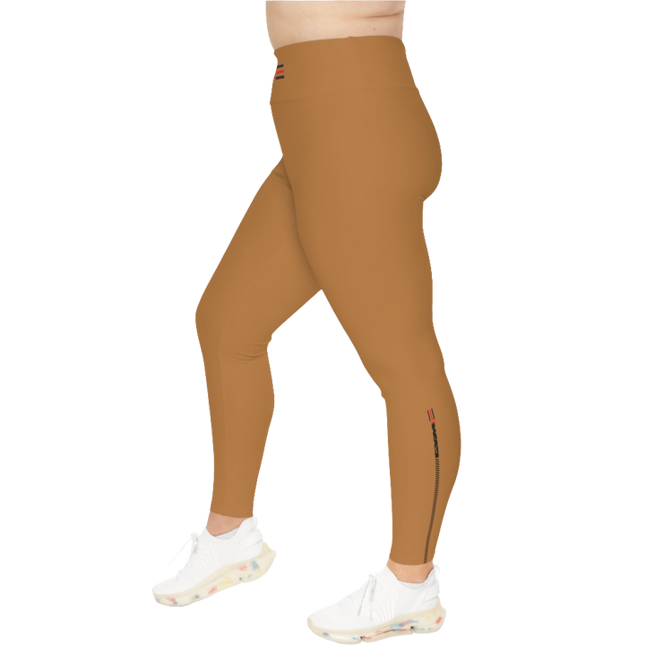 A woman wearing pair of brown high-waisted Gymstar fitness leggings with a logo on the upper left thigh, paired with white sneakers. Right side view.