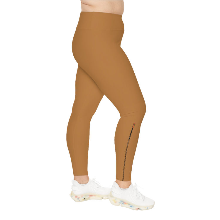 A woman wearing pair of brown high-waisted Gymstar fitness leggings with a logo on the upper left thigh, paired with white sneakers. Left side view.