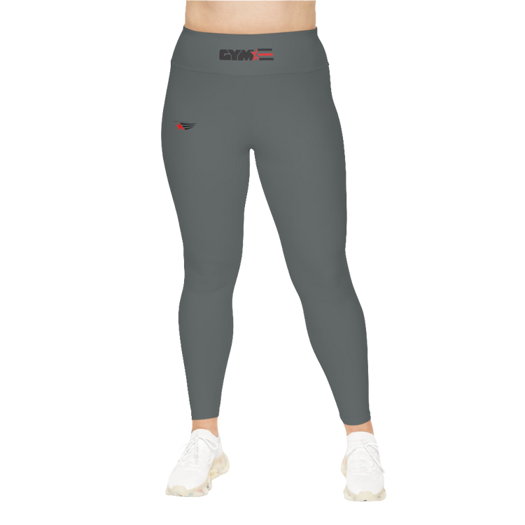 A woman wearing pair of grey high-waisted Gymstar fitness leggings with a logo on the upper left thigh, paired with white sneakers. Front view.