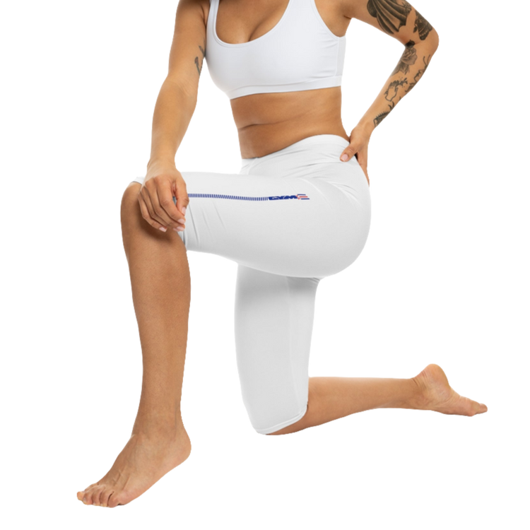 A pair of white Gymstar fitness capri leggings with blue and red detailing on the side, worn by a model facing sideways.