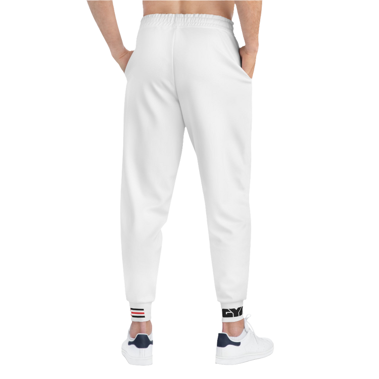 A person standing backways, wearing silver white joggers Gymstar with a logoand white sneakers. The joggers have a ribbed bottom and waistband cuffs, and feature two side pockets.