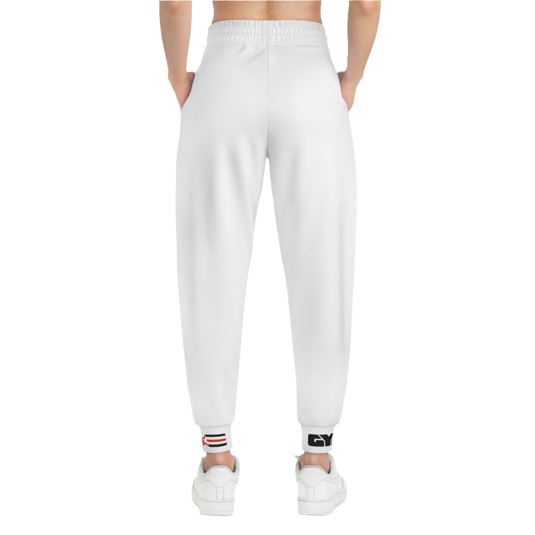 A person standing frontal, wearing silver gray joggers Gymstar with a logoand white sneakers. The joggers have a ribbed bottom and waistband cuffs, and feature two side pockets.