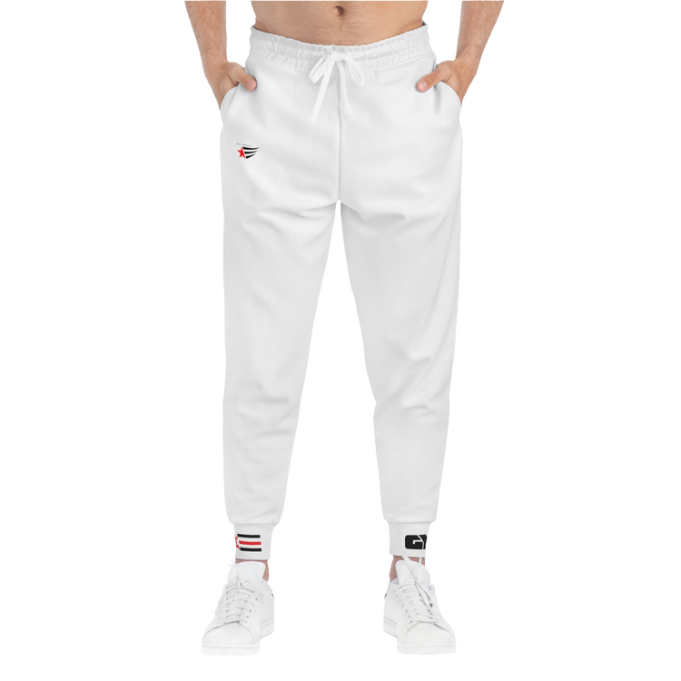 A person standing frontal, wearing silver gray joggers Gymstar with a logoand white sneakers. The joggers have a ribbed bottom and waistband cuffs, and feature two side pockets.