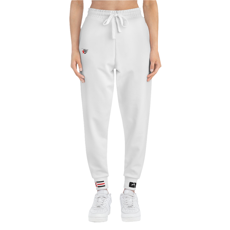 A person standing frontal, wearing silver gray joggers Gymstar with a logoand white sneakers. The joggers have a ribbed bottom and waistband cuffs, and feature two side pockets.