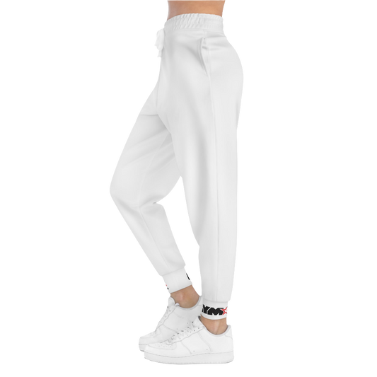 A person standing sideways, wearing silver gray joggers Gymstar with a logoand white sneakers. The joggers have a ribbed bottom and waistband cuffs, and feature two side pockets.